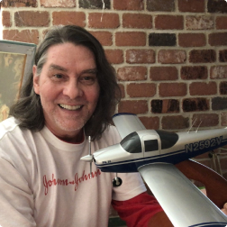 gallery image of satisfied customer holding a low wing GA aircraft model