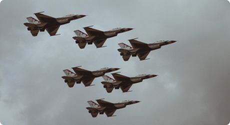 Image of Thunderbirds flying through clouds in formation