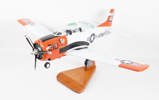 U.S. Army T‑28B Trojan model in white, orange, and black with insignia and cockpit detail on wooden stand