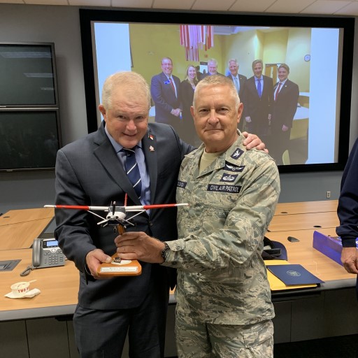 Civil Air Patrol CAP C182T model on wooden stand held during retirement ceremony