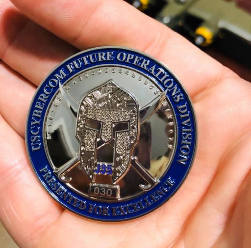USCYBERCOM Future Operations Division challenge coin held in hand, symbolizing modern excellence and tradition.