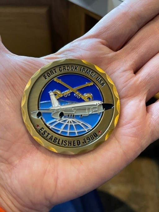 Fort Crook IPMSUSA challenge coin featuring aircraft and globe design