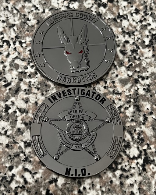 Front and back of Lowndes County Narcotics Investigator challenge coin showing bulldog mascot and sheriff’s badge design.