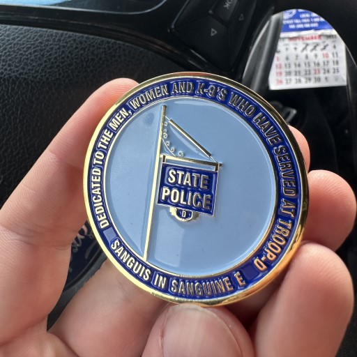 Back of Connecticut State Police Troop D challenge coin featuring blue flag design and engraved years 1941 to 2023.
