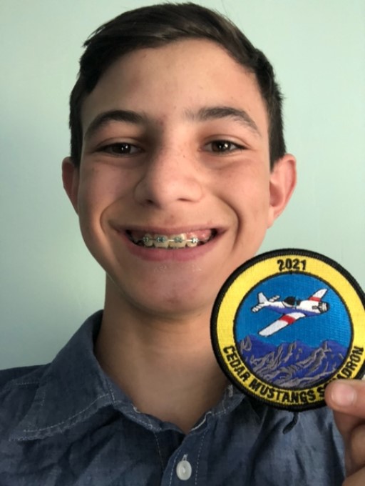 Civil Air Patrol Cedar Mustangs Squadron embroidered patch held by cadet showing CAP pride and confidence in custom gear quality