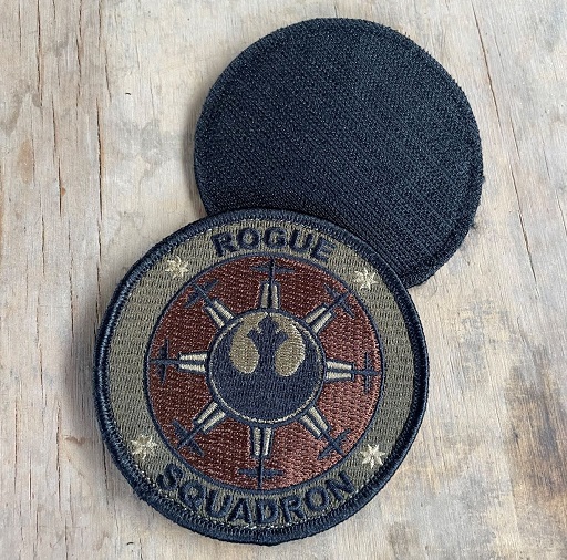 Two 75th Expeditionary Airlift Squadron Rogue OCP patches on wood surface, one showing velcro back