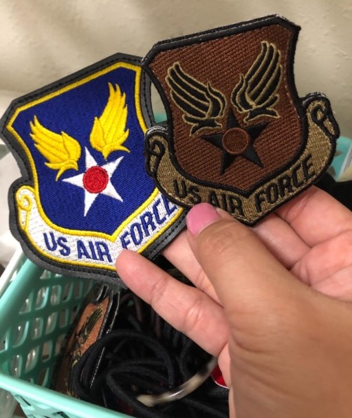 Two U.S. Air Force patches showing heraldic wings, star, and scroll design