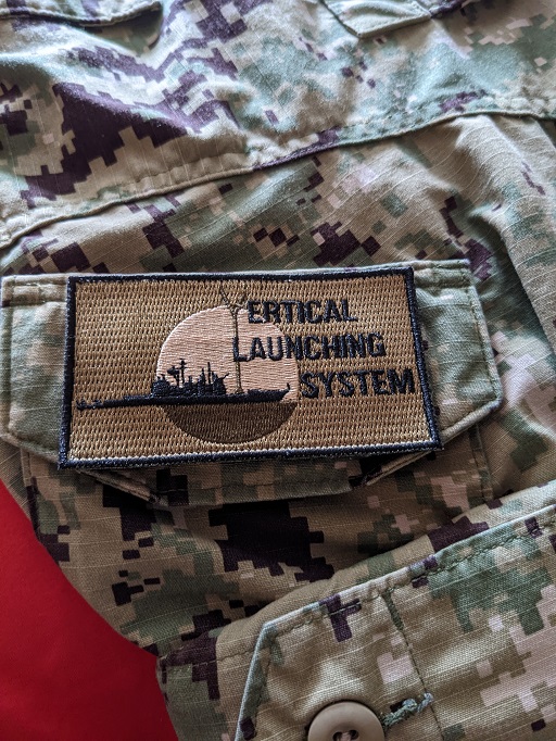 NSWC Port Hueneme NWU Type III patch on Navy uniform with ship emblem and text Vertical Launching System