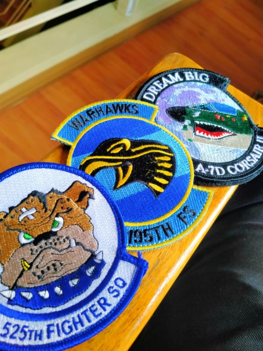 Three different embroidered squadron patches displayed side by side, showing variety in design and unit identity