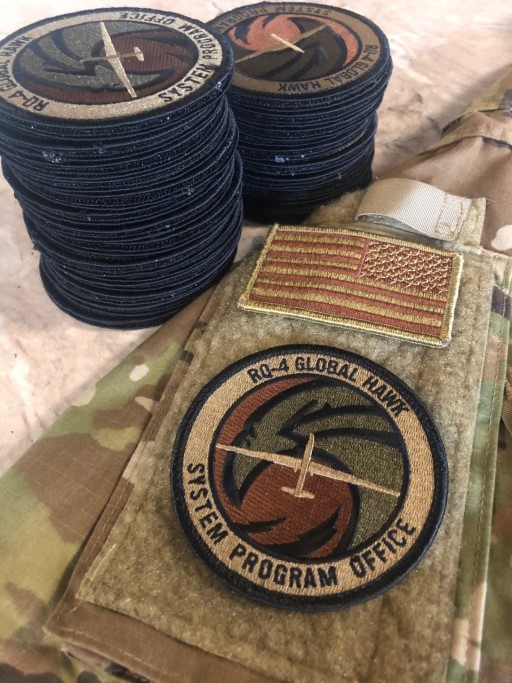 RQ‑4 Global Hawk System Program Office OCP patch displayed on a uniform with identical patches stacked beside it