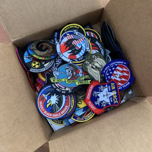 Collage of six people each holding military aircraft models on wooden stands