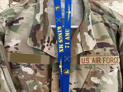 71 AMU lanyard draped over uniform with printed text, logos, lobster hook, plastic buckle, and safety breakaway
