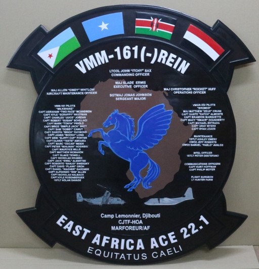 Custom VMM‑161 deployment plaque featuring aircraft artwork, mission details, flags, and names of squadron members