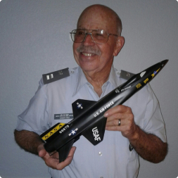 gallery image of satisfied customer in uniform holding a nasa aircraft model