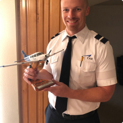gallery image of satisfied commercial airline customer holding a aircraft replica model
