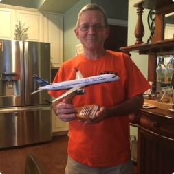 gallery image of satisfied customer holding a commercial airline model