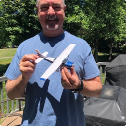 gallery image of satisfied customer holding a cessna aircraft model outside