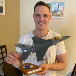 gallery image of satisfied customer holding an a-10 fighter aircraft model on triangular exhaust mount stand